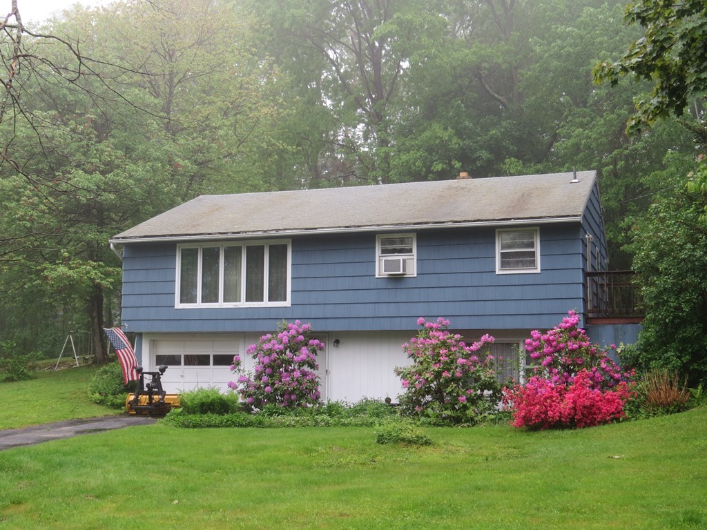 29 Birchwood Road Rutland, MA 01543 - Photo 1 of 17 a front view of a house with a garden