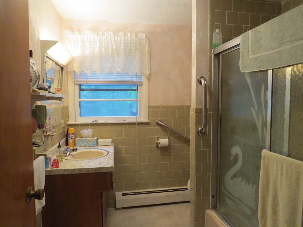 29 Birchwood Road Rutland, MA 01543 - Photo 13 of 17 a bathroom with a sink a mirror and shower