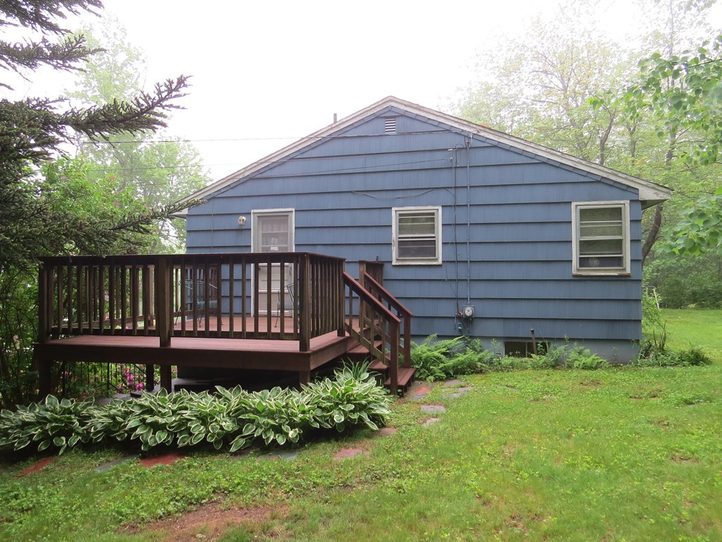 29 Birchwood Road Rutland, MA 01543 - Photo 15 of 17 a view of a wooden house with a small yard and large trees