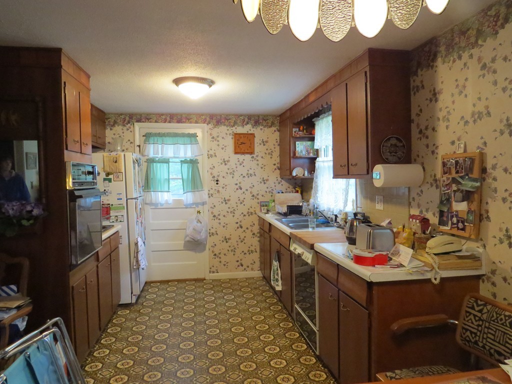 29 Birchwood Road Rutland, MA 01543 - Photo 8 of 17 a kitchen with a sink stove and refrigerator