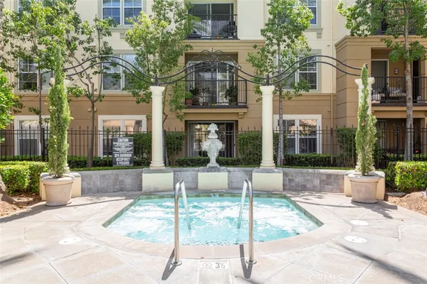 a view of a building with a garden in the background
