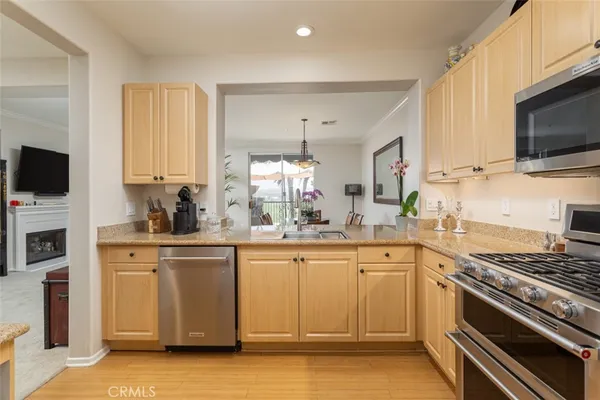 a kitchen with stainless steel appliances a stove microwave and sink