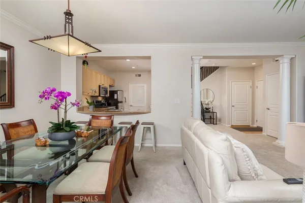 a dining room with furniture and a chandelier