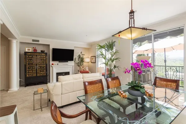 a living room with furniture a flat screen tv and a large window