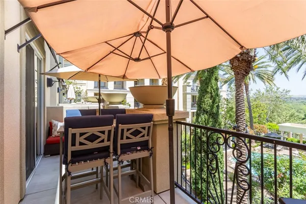 a view of a balcony with chairs and wooden fence