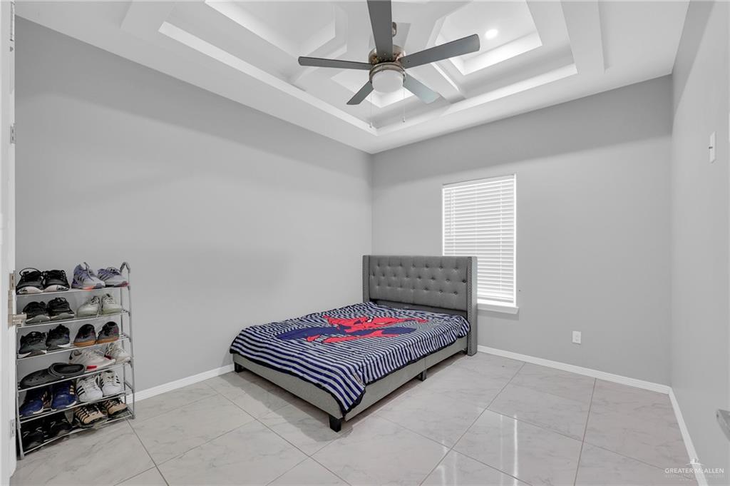 502 Oak Ridge Street Donna, TX 78537 - Photo 14 of 28 a bedroom with a bed and a dresser