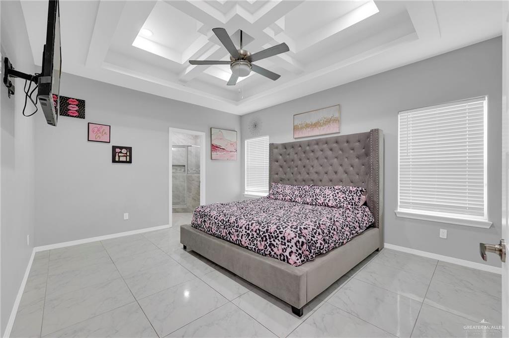 502 Oak Ridge Street Donna, TX 78537 - Photo 15 of 28 a bed room with a bed and a ceiling fan
