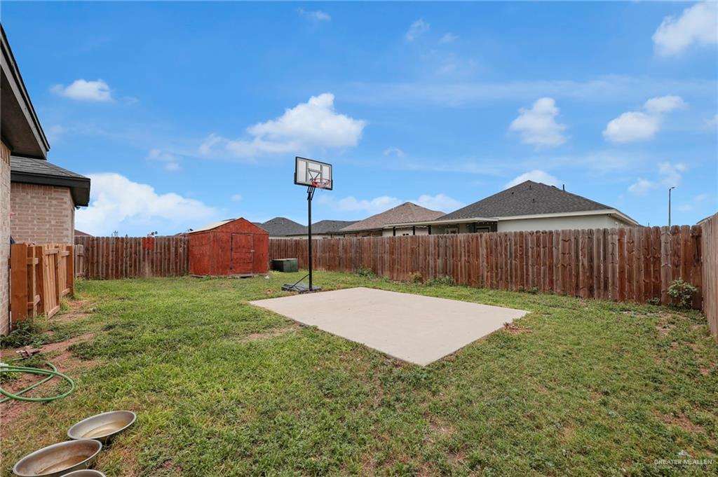 502 Oak Ridge Street Donna, TX 78537 - Photo 17 of 28 a view of backyard with table and chairs a wooden fence