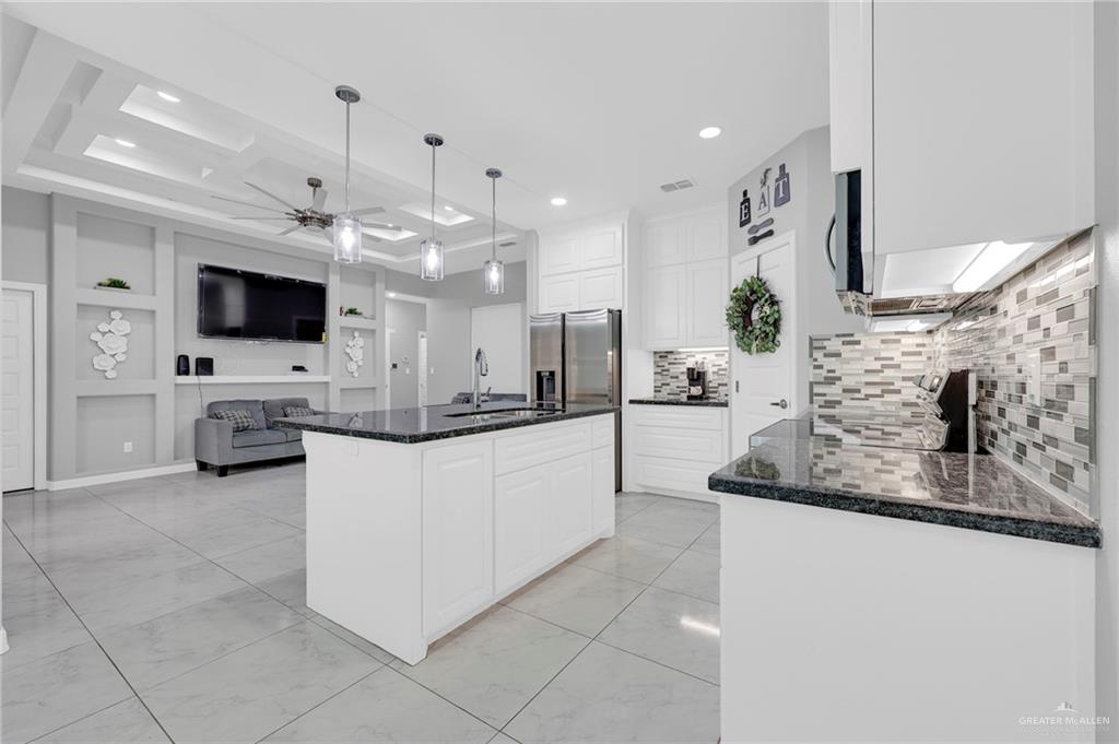 502 Oak Ridge Street Donna, TX 78537 - Photo 4 of 28 a large white kitchen with a large window and stainless steel appliances