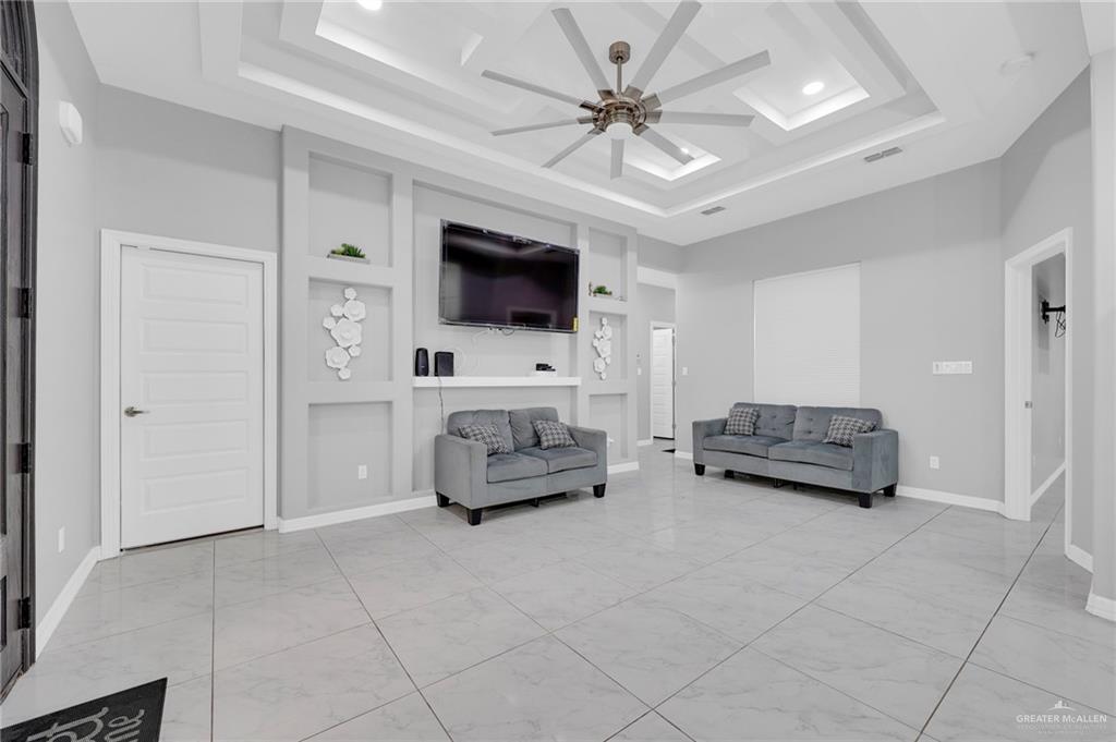 502 Oak Ridge Street Donna, TX 78537 - Photo 7 of 28 a living room with furniture and a flat screen tv