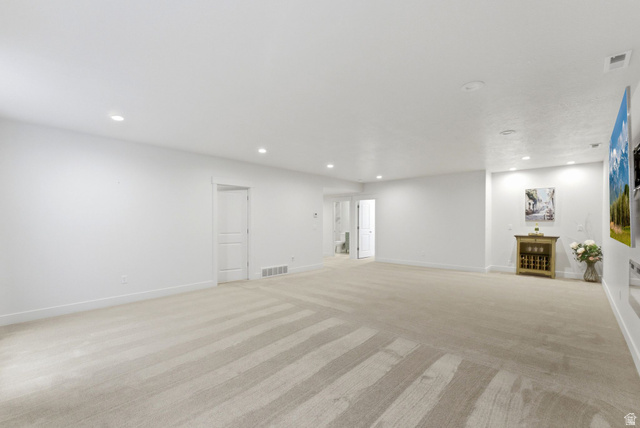 108 West Monte Rosa Lane Midway, UT 84049 - Photo 36 of 48 Spacious room featuring light-toned carpeting, recessed ceiling lighting, and white walls
