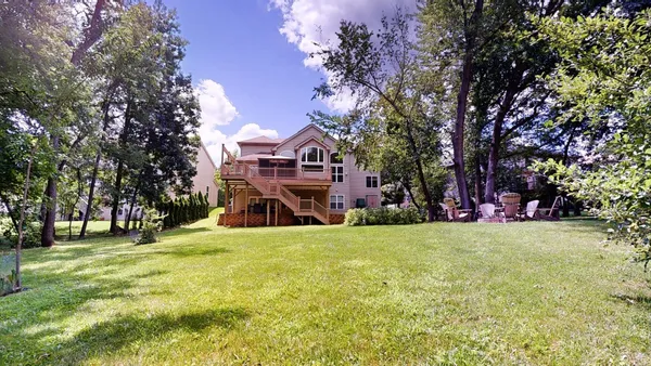 a front view of a house with a yard covered in snow