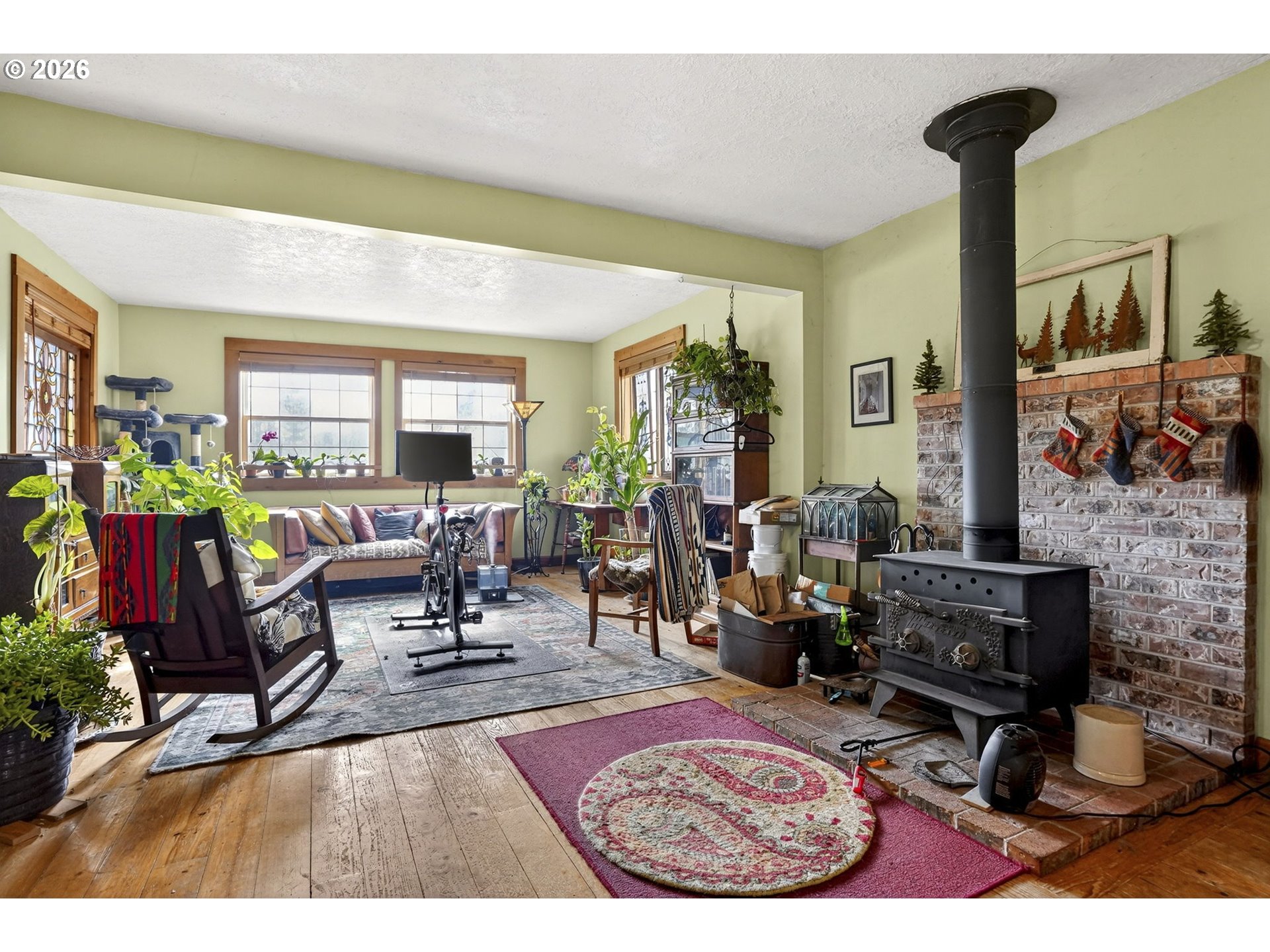 24677 Southeast Van Curen Road Eagle Creek, OR 97022 - Photo 46 of 48 a living room with furniture dining table and a fireplace