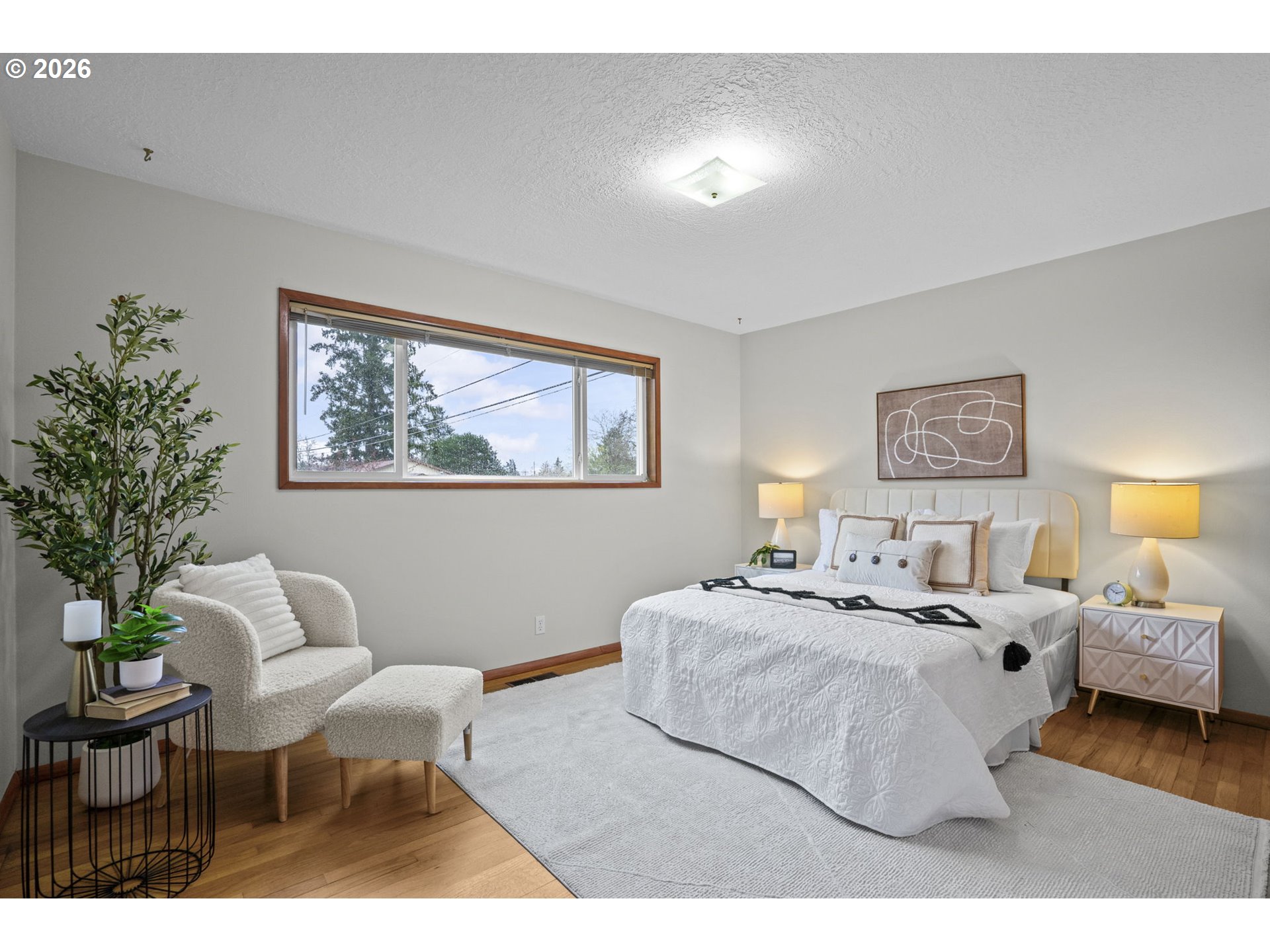 10531 Southeast Long Street Portland, OR 97266 - Photo 16 of 42 a bedroom with a bed and a painting on the wall