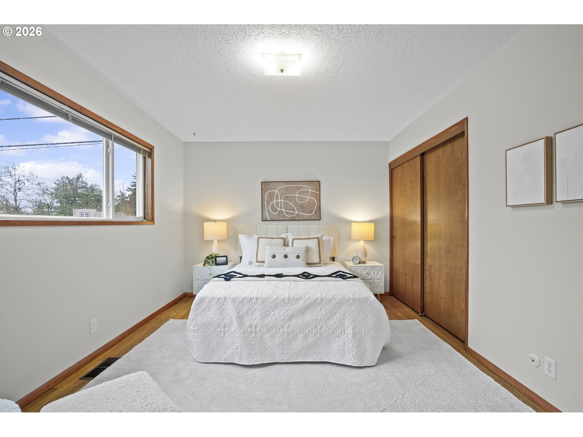 10531 Southeast Long Street Portland, OR 97266 - Photo 17 of 42 a bedroom with a bed and a painting on the wall