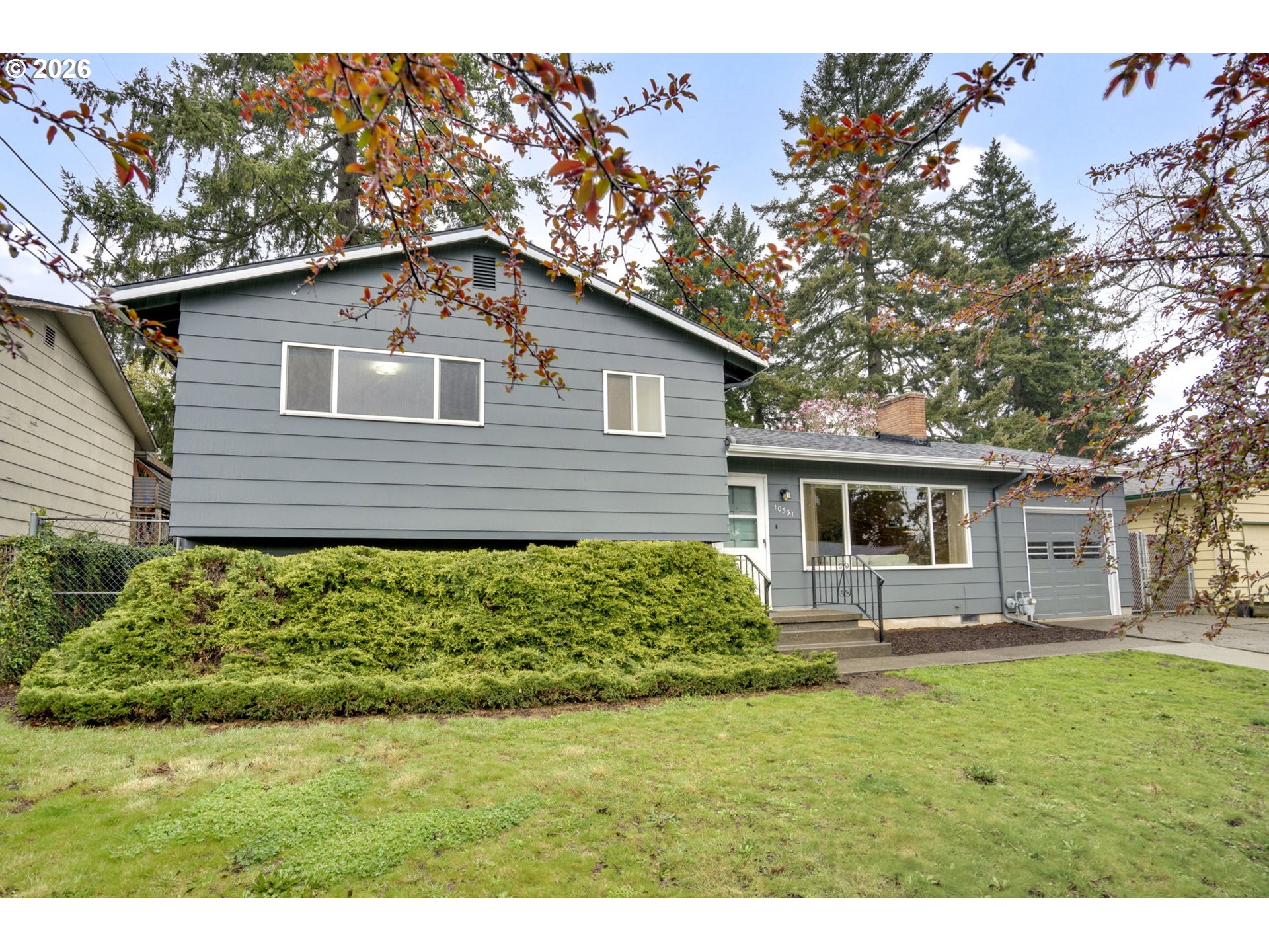 10531 Southeast Long Street Portland, OR 97266 - Photo 2 of 42 a front view of a house with garden