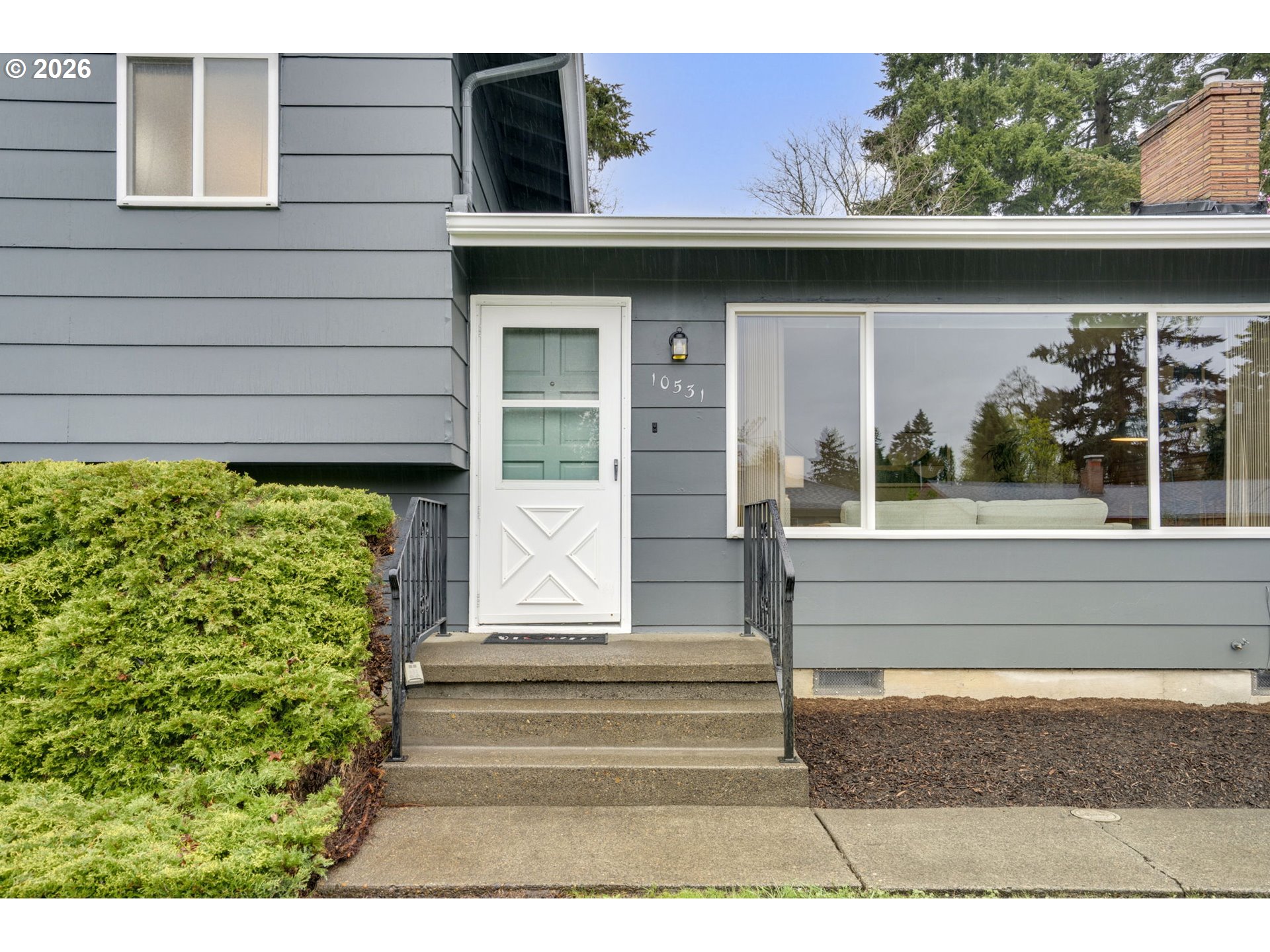10531 Southeast Long Street Portland, OR 97266 - Photo 3 of 42 a side view of a house with a porch