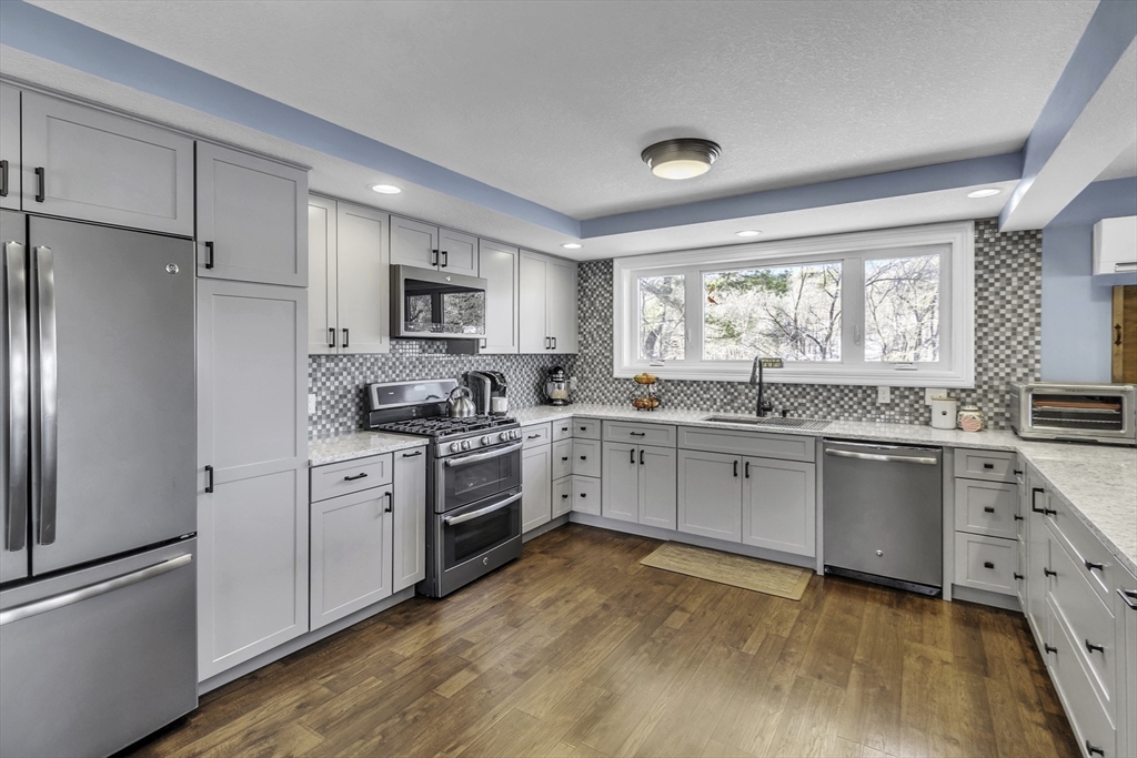 15 Grove Point Road Wales, MA 01081 - Photo 7 of 43 a kitchen with white cabinets and white appliances