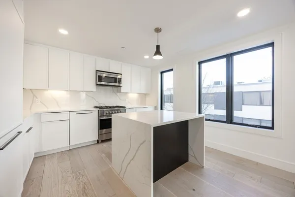 a kitchen with a sink stove and microwave