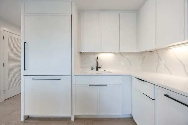 a kitchen with a sink and cabinets