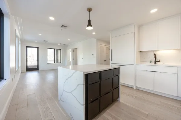 a kitchen with a sink microwave and cabinets
