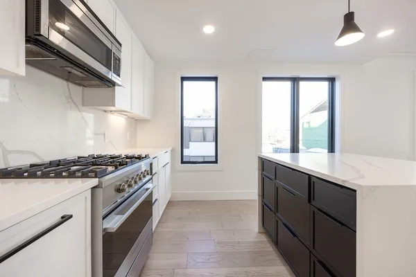 a kitchen with stainless steel appliances granite countertop a stove and a sink