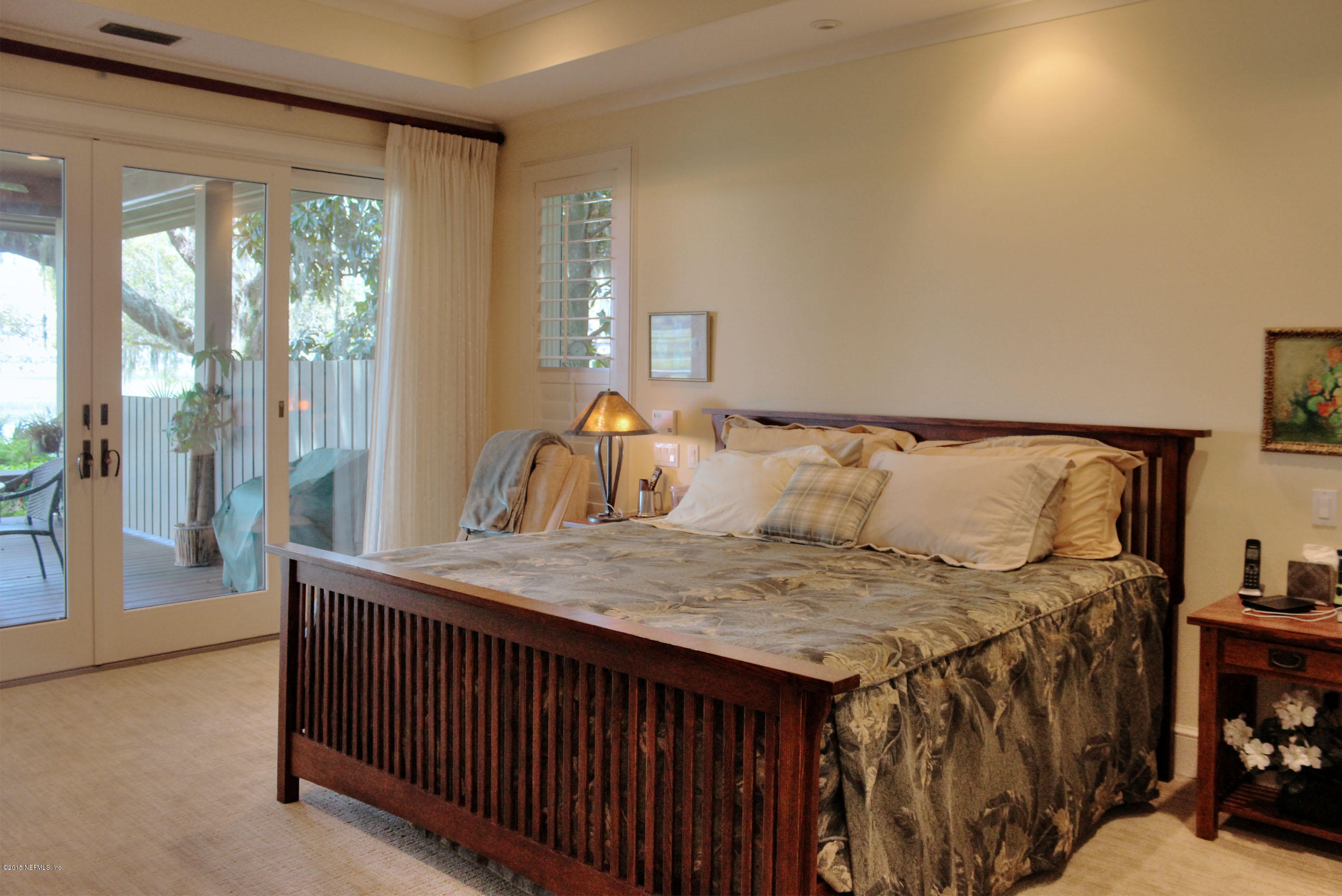 22 Sea Marsh Road Fernandina Beach, FL 32034 - Photo 16 of 24 a bedroom with a bed and large windows