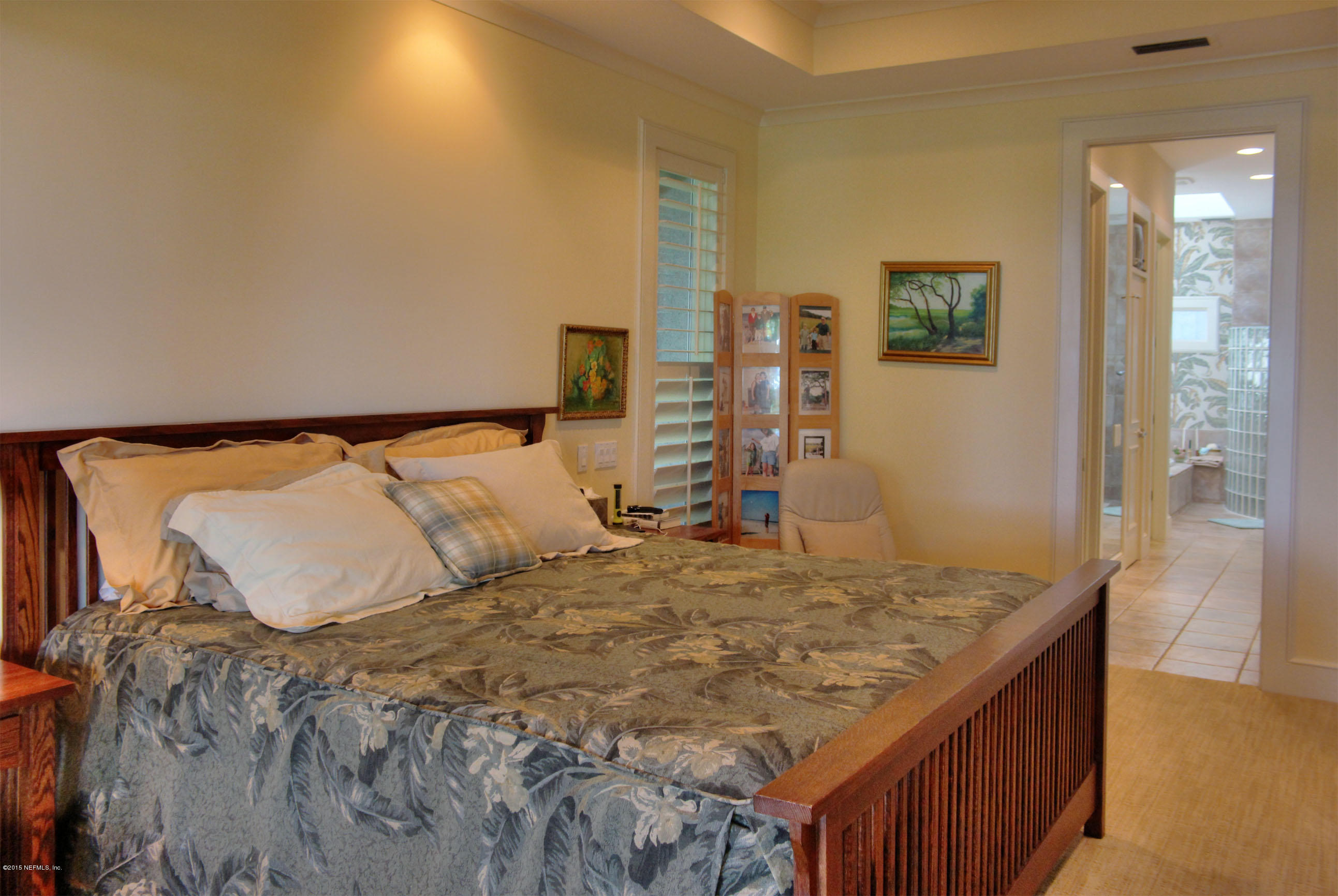 22 Sea Marsh Road Fernandina Beach, FL 32034 - Photo 17 of 24 a bed sitting in a bedroom next to a bathroom