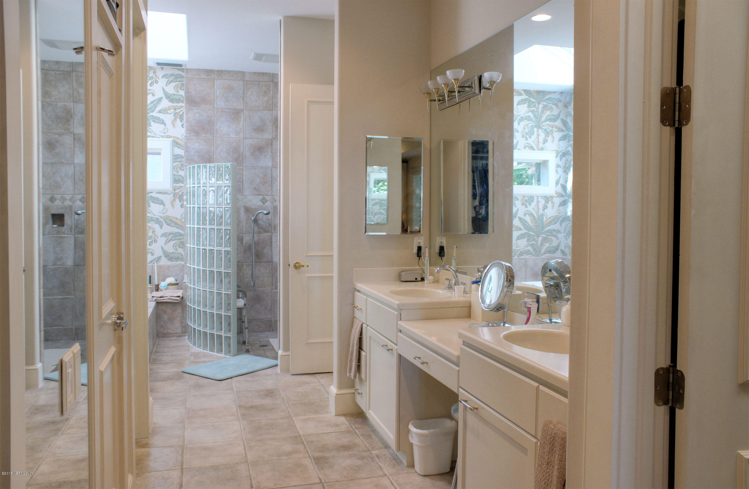 22 Sea Marsh Road Fernandina Beach, FL 32034 - Photo 19 of 24 a bathroom with a double vanity sink mirror and shower