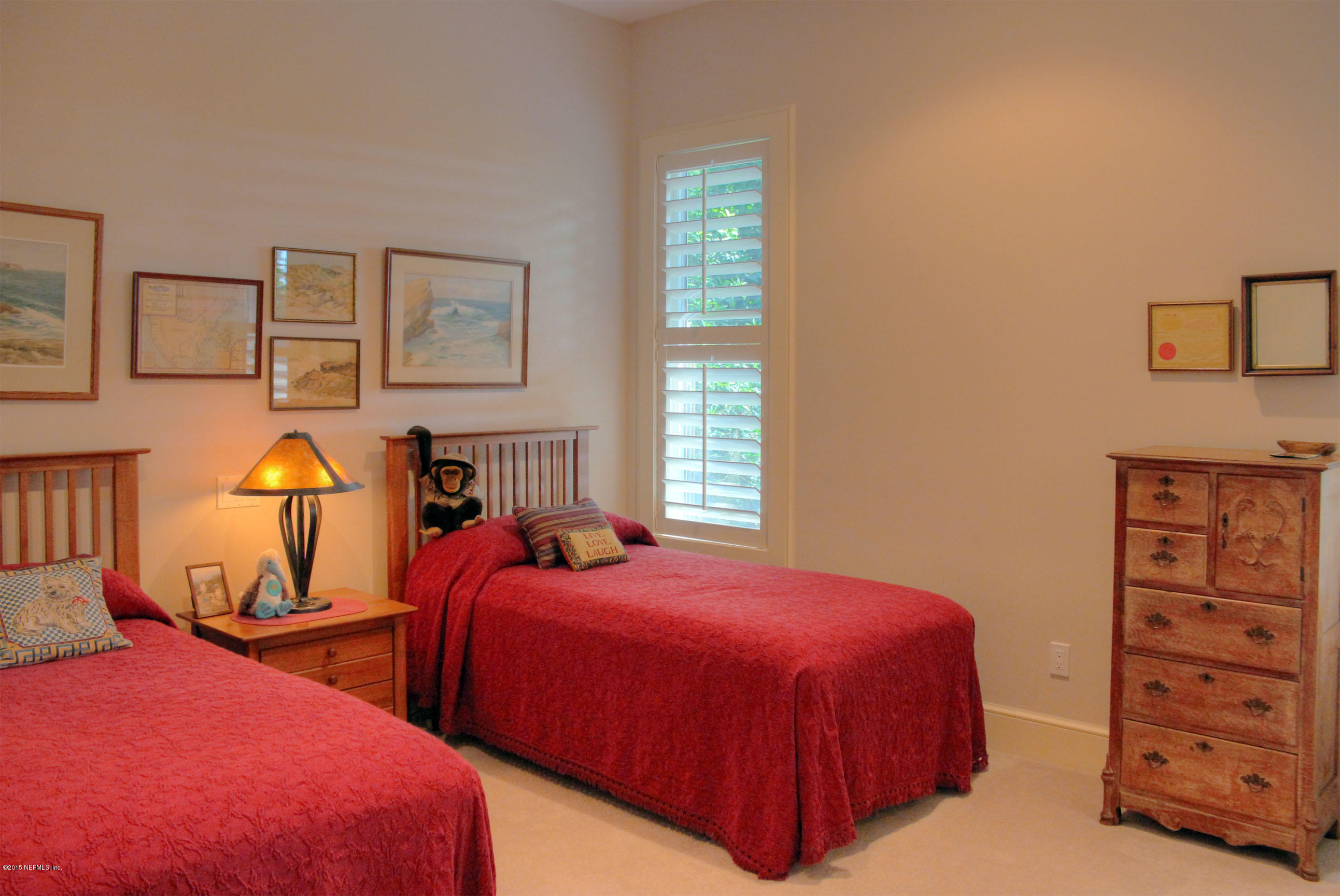 22 Sea Marsh Road Fernandina Beach, FL 32034 - Photo 20 of 24 a bedroom with two beds and painting on the wall
