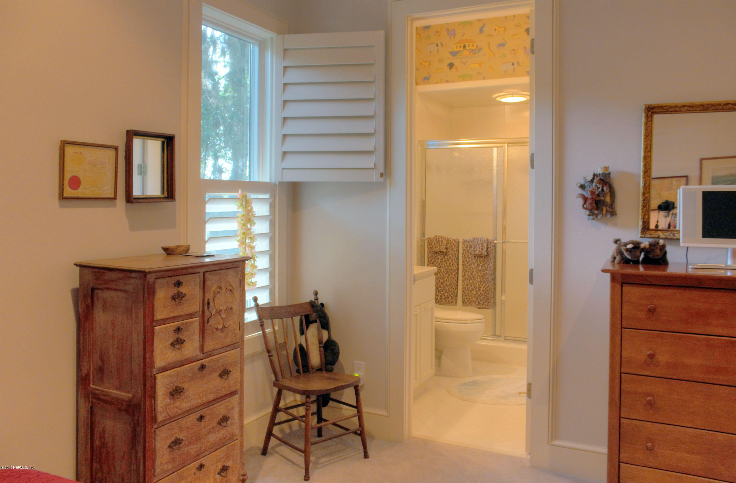 22 Sea Marsh Road Fernandina Beach, FL 32034 - Photo 21 of 24 a view of a bedroom with a window and cabinet