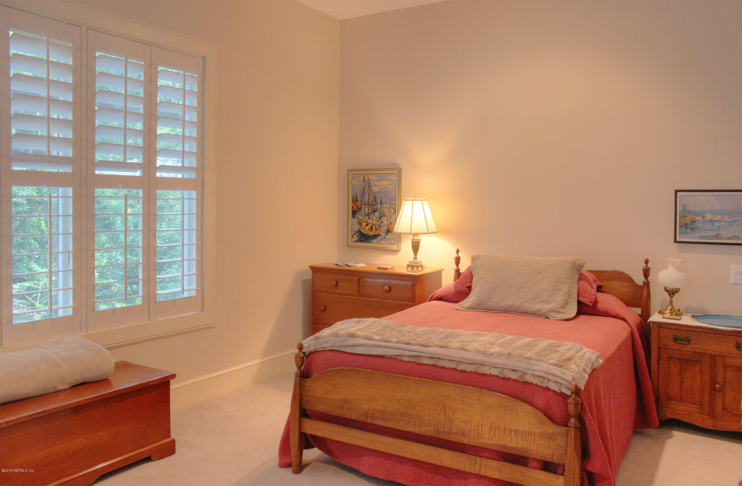 22 Sea Marsh Road Fernandina Beach, FL 32034 - Photo 22 of 24 a bedroom with a bed and a couch next to a window