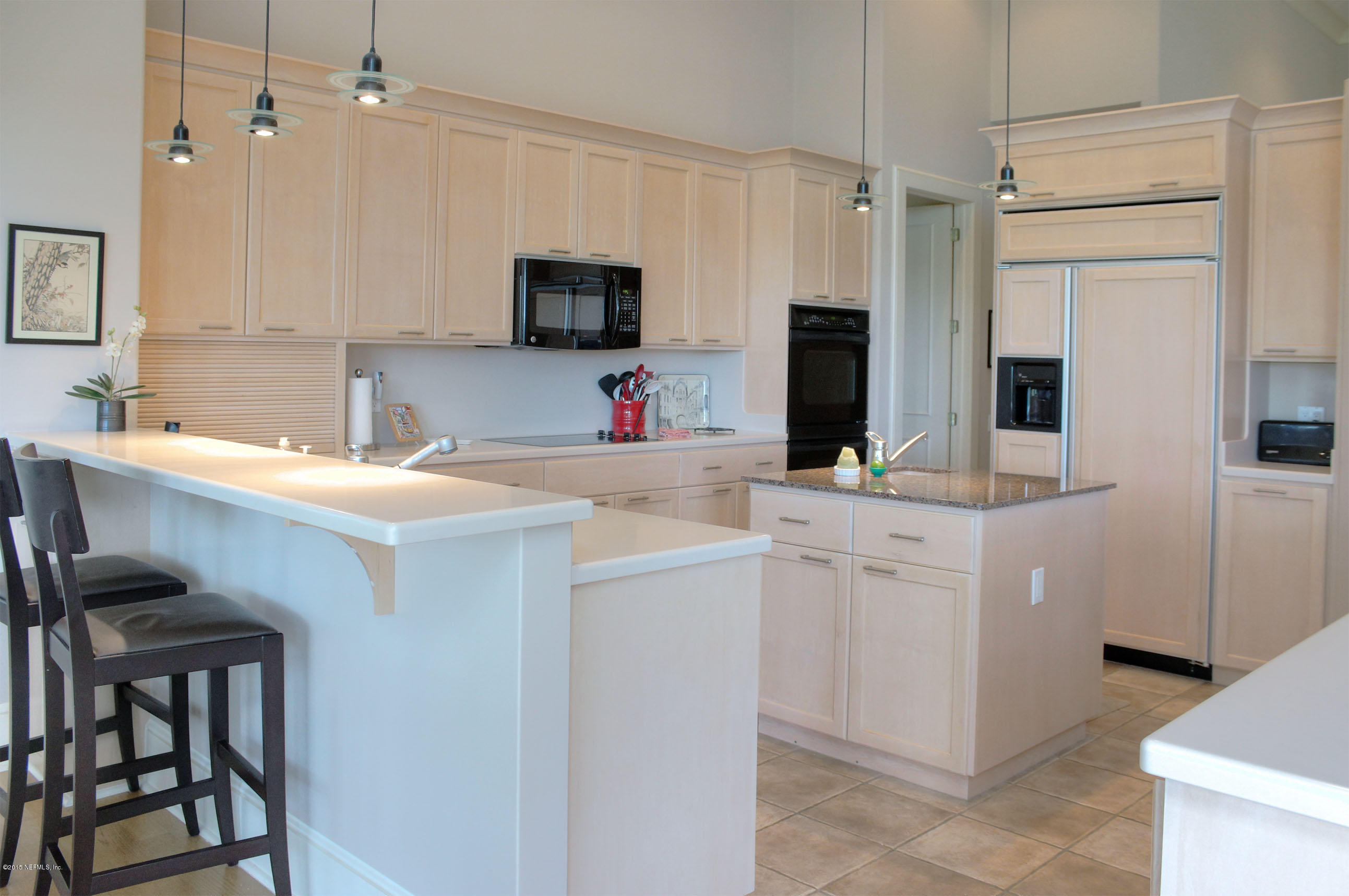22 Sea Marsh Road Fernandina Beach, FL 32034 - Photo 7 of 24 a kitchen with a sink cabinets and stainless steel appliances