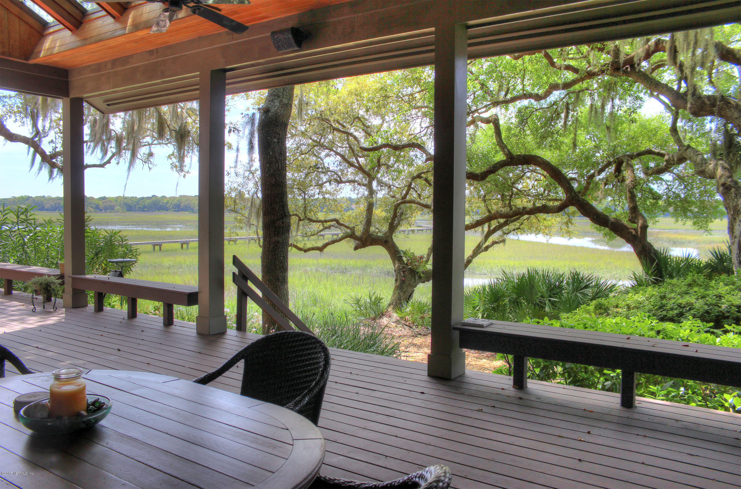 22 Sea Marsh Road Fernandina Beach, FL 32034 - Photo 10 of 24 a view of a deck with wooden floor and floor to ceiling windows with wooden floor