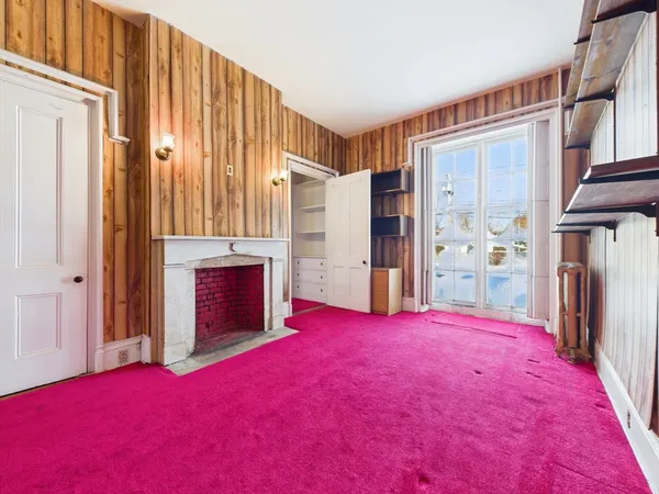 a view of staircase with white walls and a window