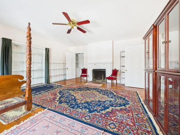 a view of an empty room with window and a fireplace