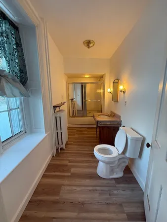 a living room with fireplace furniture and a large window