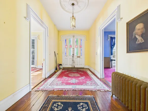 a spacious bedroom with a bed and wooden floor