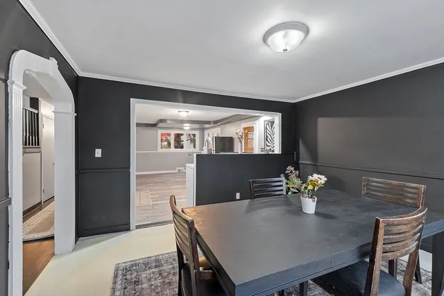 a view of a dining room with a table and chairs