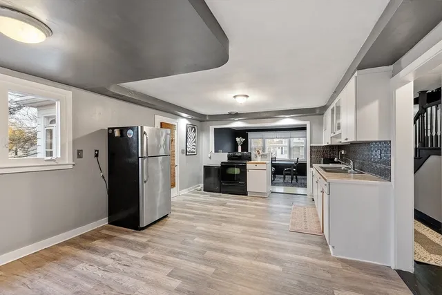 a kitchen with refrigerator and cabinets