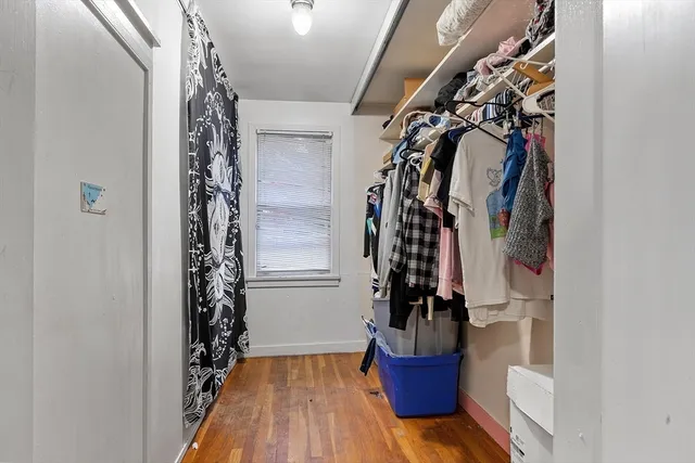 a view of a hallway with wooden floor and stairs