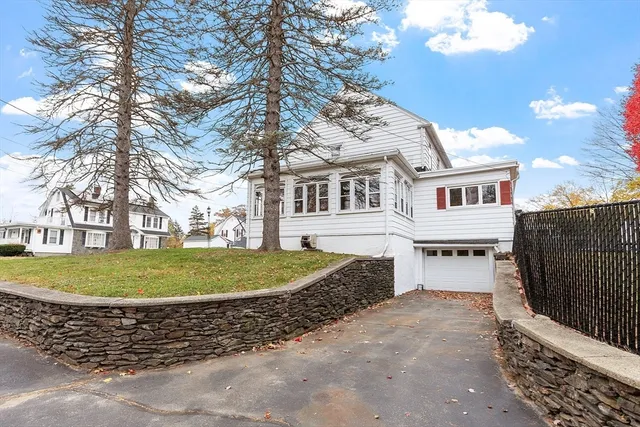 a view of a white house with a yard