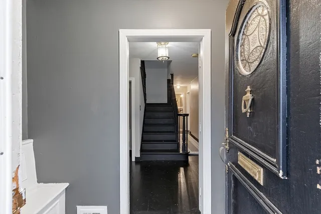 a view of an entryway with wooden floor