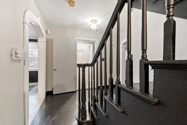 a view of entryway with wooden floor and stairs