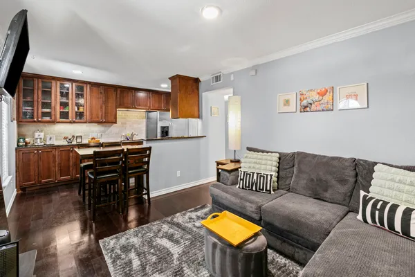 a living room with furniture and a kitchen area