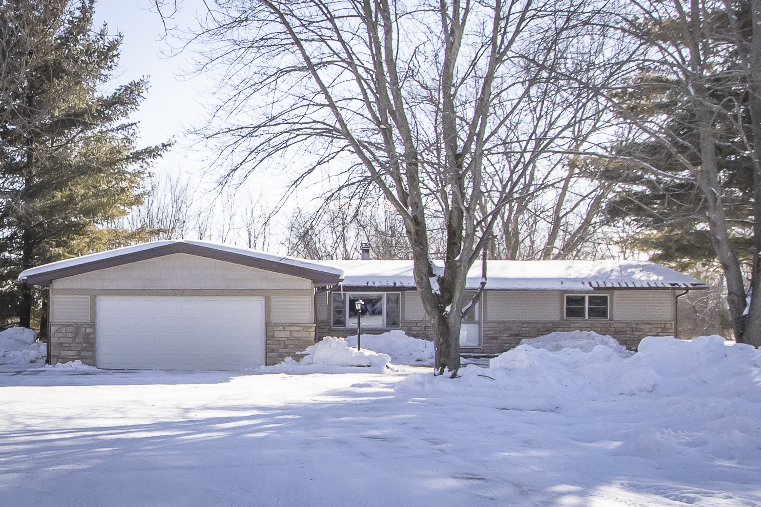 6546 Cherry Valley Road Kingston, IL 60145 - Photo 1 of 51 a front view of a house with a yard and garage