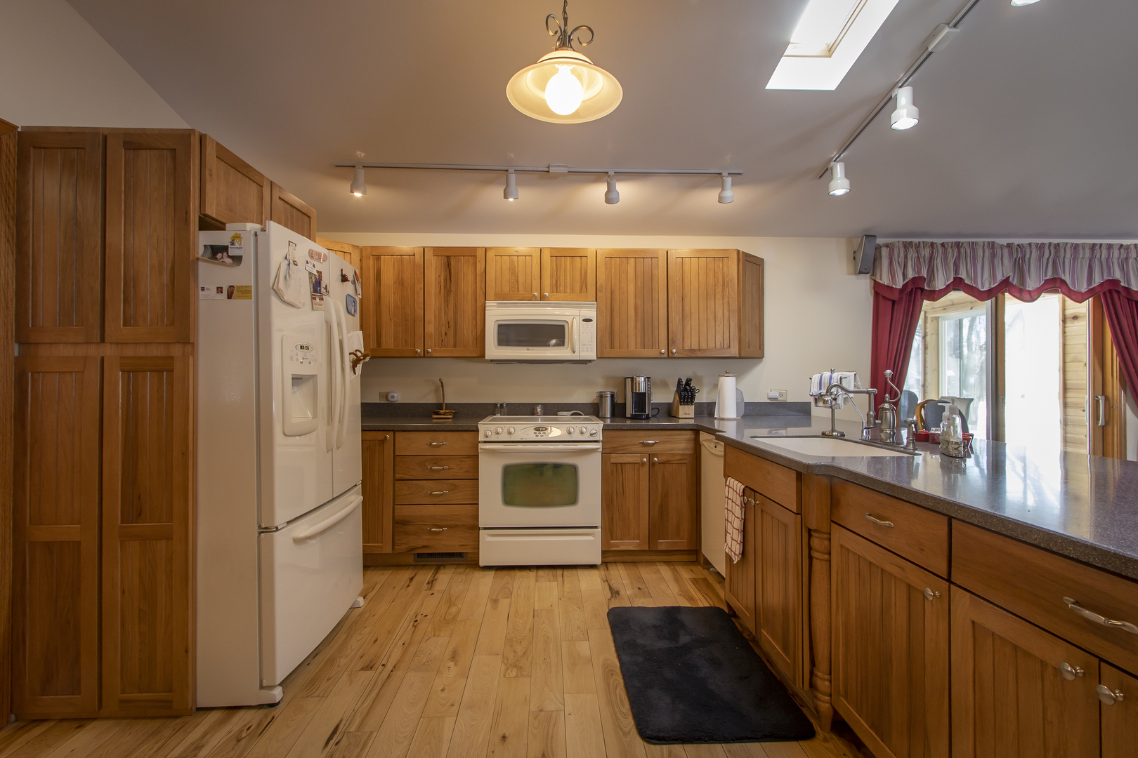 6546 Cherry Valley Road Kingston, IL 60145 - Photo 8 of 51 a kitchen with a refrigerator a sink and cabinets