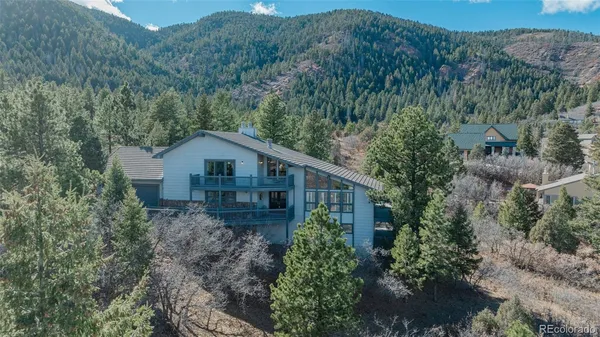 an aerial view of a house next to a yard