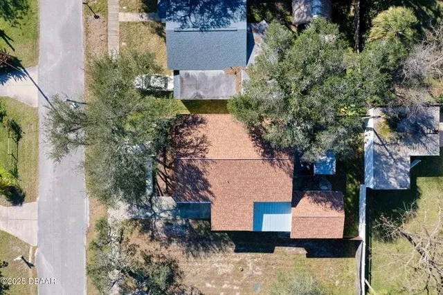 an aerial view of a house with a yard