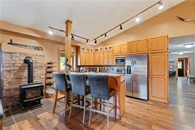 a dining table with chairs and kitchen view